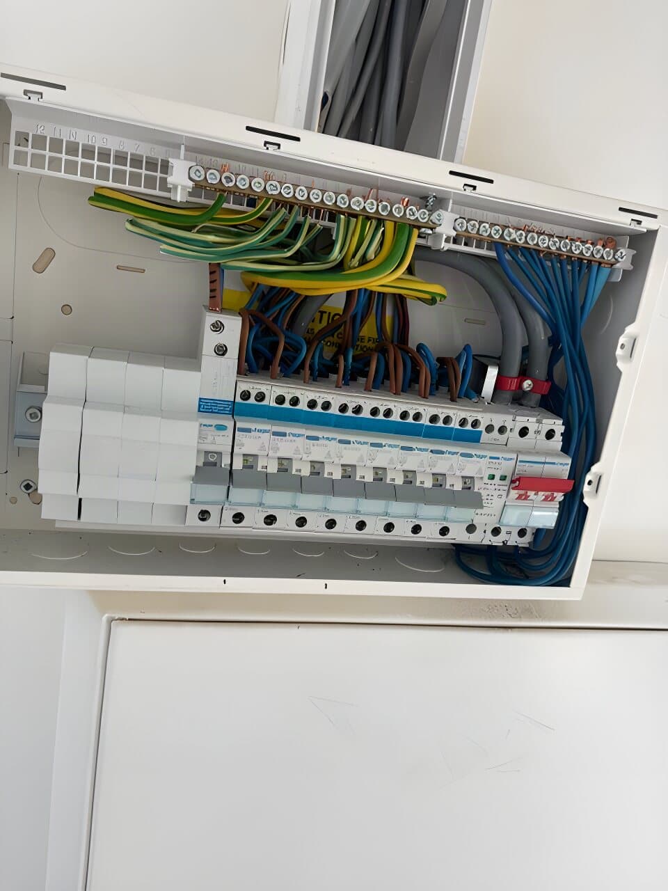New consumer unit fitted in a cupboard, cables tidied into the board