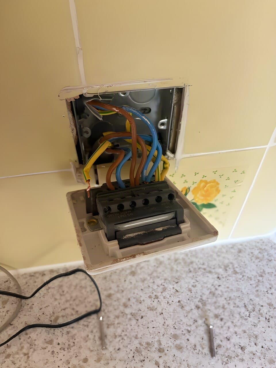 Kitchen wall box opened up and wired on a tiled splashback